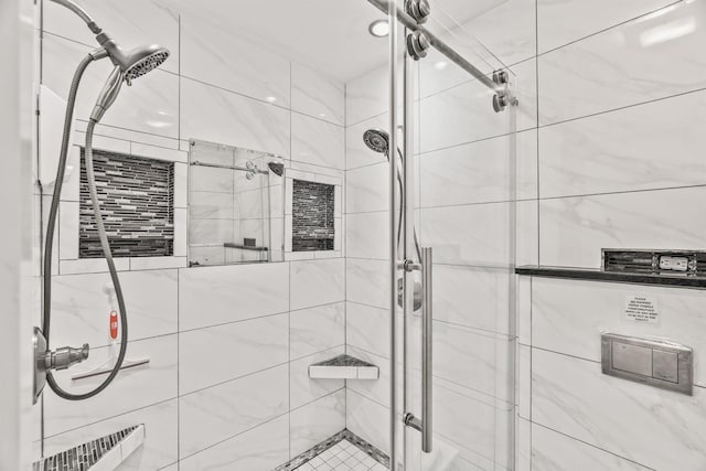 bathroom with radiator and a tile shower