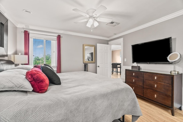 bedroom with ceiling fan, crown molding, and light wood-type flooring