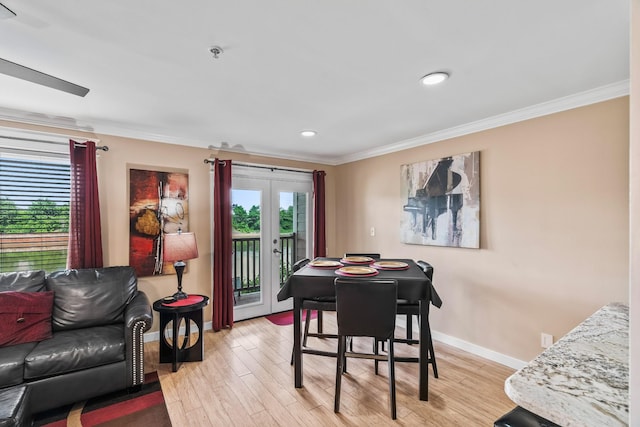 dining area with crown molding, french doors, and light wood-type flooring