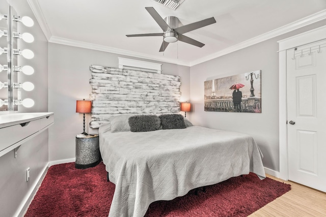 bedroom with ceiling fan, wood-type flooring, and crown molding