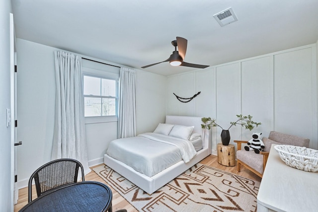 bedroom with ceiling fan and light wood-type flooring