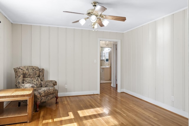 sitting room featuring crown molding, ceiling fan, and light hardwood / wood-style flooring