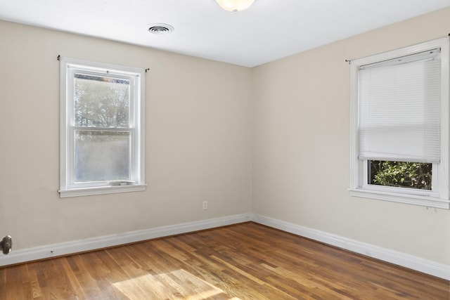 spare room with dark hardwood / wood-style floors