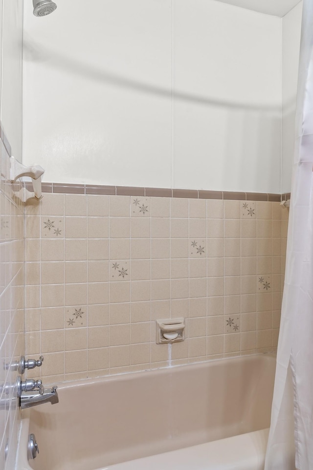 bathroom with shower / bath combo with shower curtain