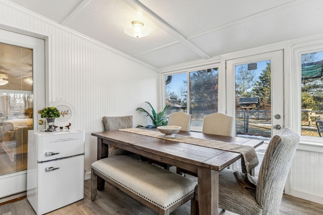 dining space with light hardwood / wood-style floors, ceiling fan, and a healthy amount of sunlight