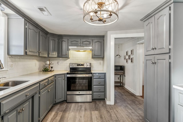 kitchen featuring electric stove, dark hardwood / wood-style floors, and gray cabinetry