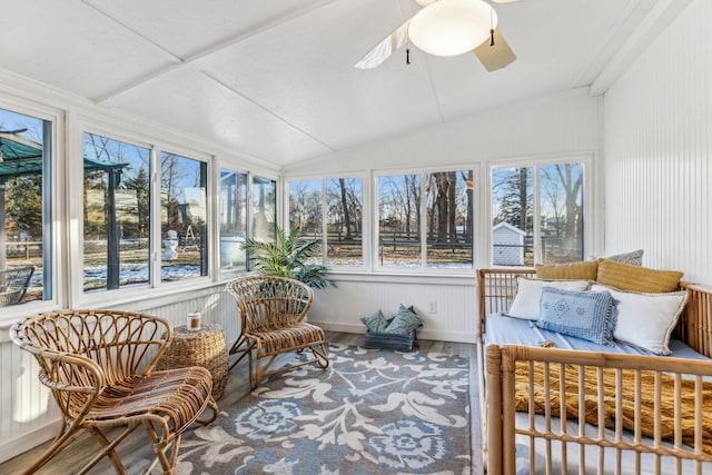 sunroom with ceiling fan and lofted ceiling