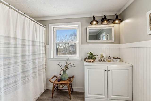 bathroom featuring hardwood / wood-style flooring, a textured ceiling, vanity, and a shower with curtain