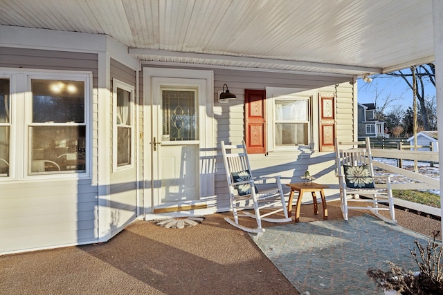 view of exterior entry featuring covered porch