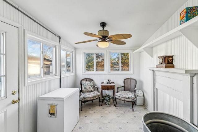 sunroom featuring ceiling fan and a healthy amount of sunlight