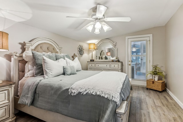 bedroom with ceiling fan, lofted ceiling, hardwood / wood-style flooring, and access to outside