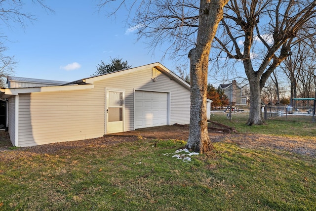 exterior space with a garage and a yard