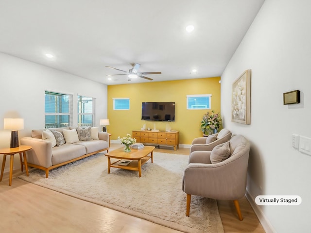 living room featuring ceiling fan and wood-type flooring