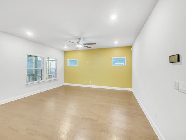 empty room with ceiling fan and light wood-type flooring