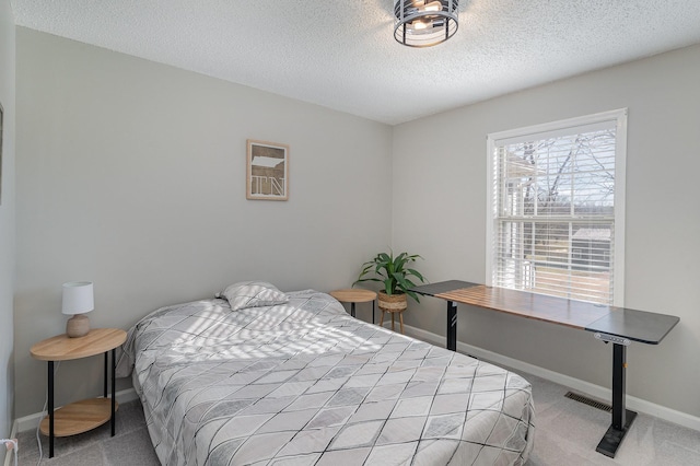 carpeted bedroom with a textured ceiling