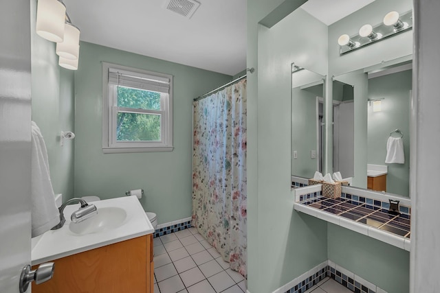 bathroom featuring toilet, a shower with curtain, tile patterned floors, and vanity