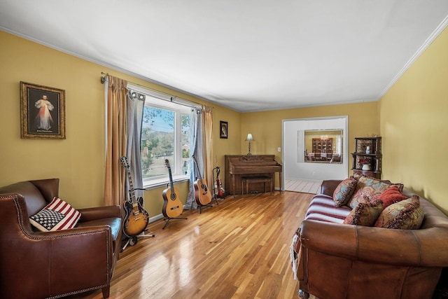 living room with crown molding and light hardwood / wood-style floors