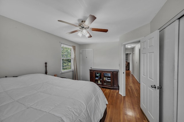 bedroom with ceiling fan and hardwood / wood-style flooring