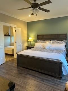 bedroom with ceiling fan, crown molding, and dark hardwood / wood-style floors