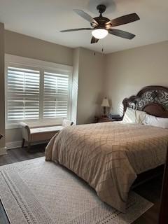 bedroom with ceiling fan and hardwood / wood-style flooring