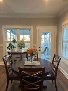 dining space with dark hardwood / wood-style floors, a wealth of natural light, and ornamental molding