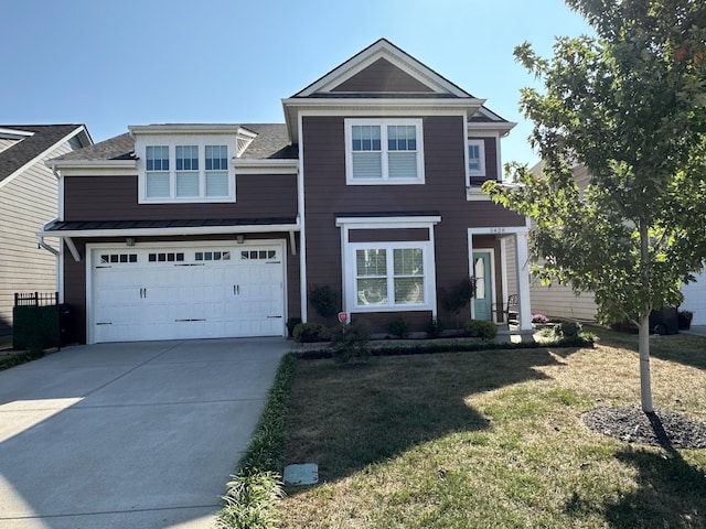 view of front of property with a front yard and a garage