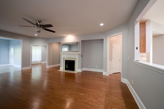 unfurnished living room featuring hardwood / wood-style flooring and ceiling fan