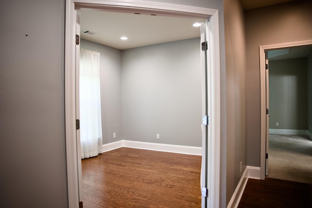 hallway with dark wood-type flooring