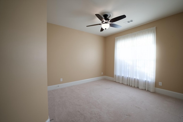 carpeted empty room featuring ceiling fan