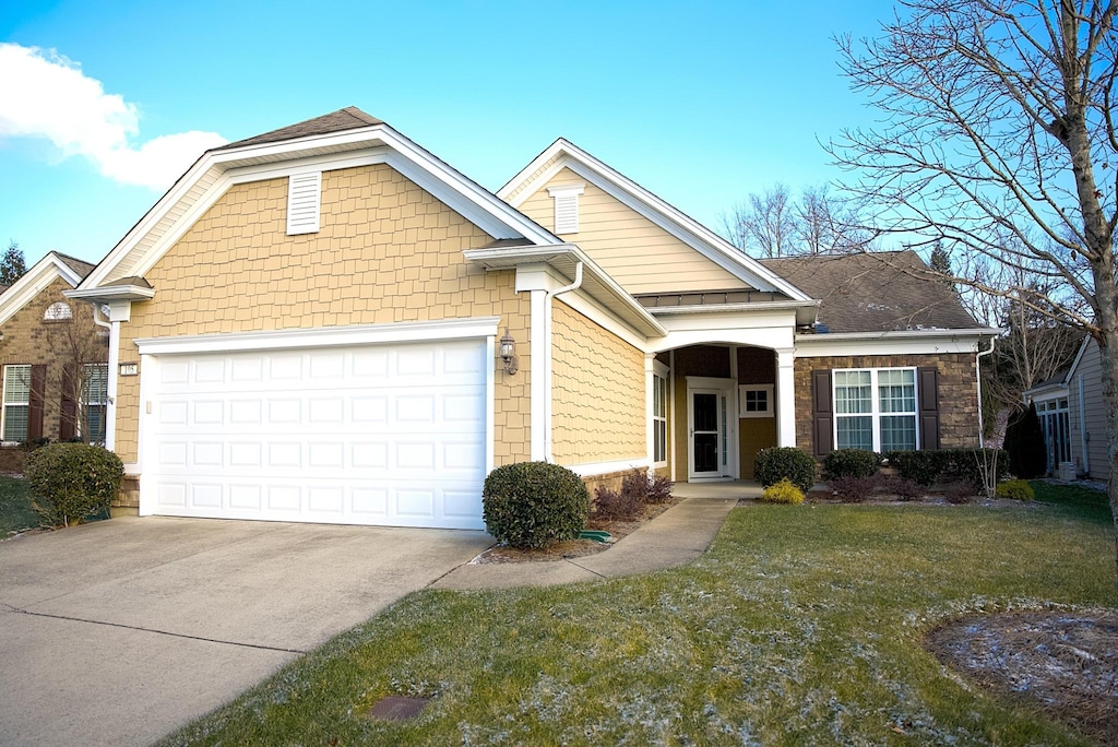 view of front of house with a garage and a front lawn