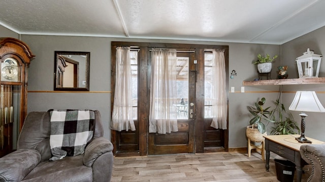 entryway featuring a textured ceiling and light hardwood / wood-style floors