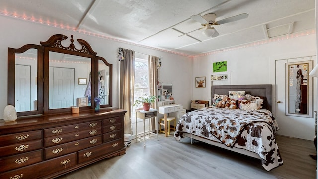 bedroom featuring ceiling fan and light hardwood / wood-style flooring