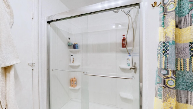 bathroom with a shower with shower door