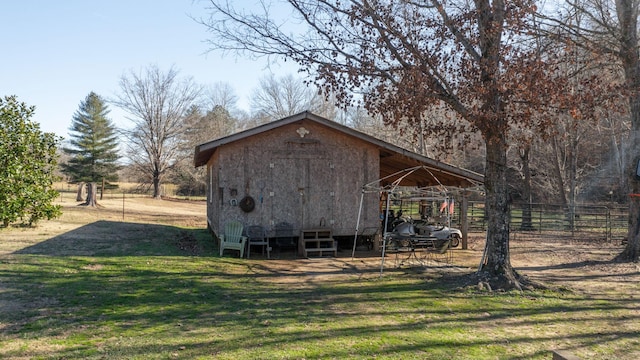 view of outbuilding featuring a yard