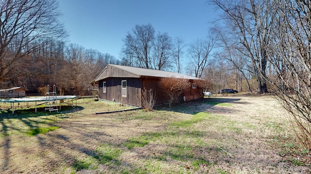 view of side of property with a trampoline