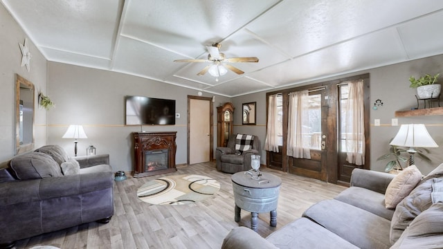 living room featuring light hardwood / wood-style floors and ceiling fan