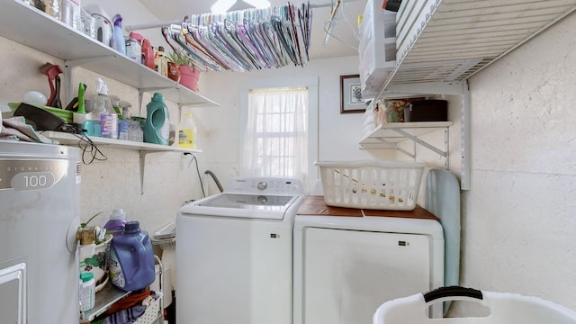 washroom featuring water heater and separate washer and dryer