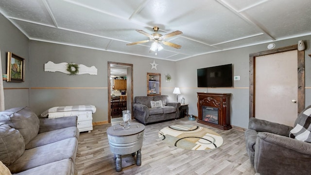 living room with ceiling fan and wood-type flooring