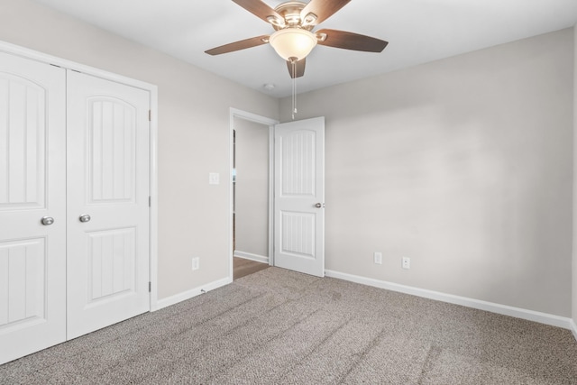 unfurnished bedroom with ceiling fan, a closet, and carpet flooring