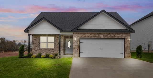 view of front of home featuring a yard and a garage