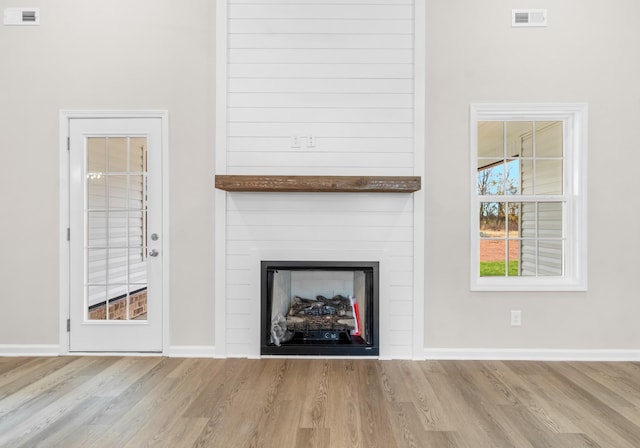 interior details featuring a fireplace and hardwood / wood-style flooring