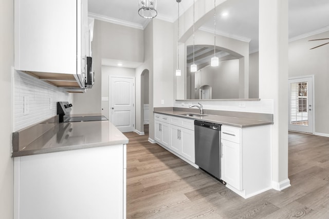 kitchen with decorative light fixtures, backsplash, light hardwood / wood-style floors, stainless steel appliances, and white cabinets