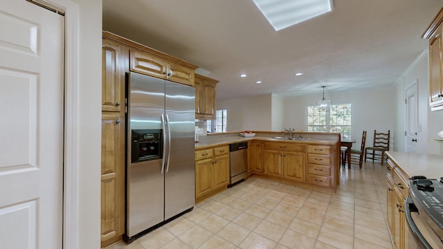 kitchen with sink, decorative light fixtures, ornamental molding, kitchen peninsula, and stainless steel appliances