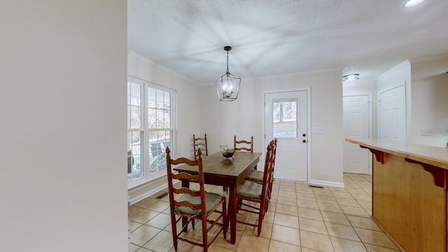 tiled dining room featuring ornamental molding and a healthy amount of sunlight