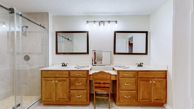 bathroom with tile patterned flooring, vanity, and a shower with shower door