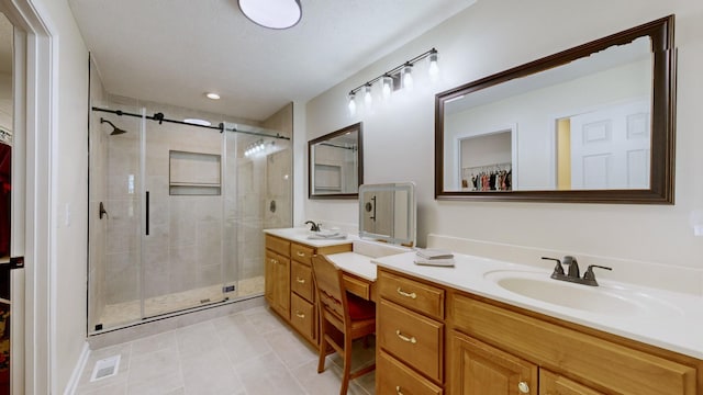 bathroom featuring vanity, tile patterned floors, and a shower with shower door