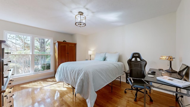 bedroom featuring multiple windows and light wood-type flooring