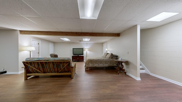 bedroom featuring dark wood-type flooring and beam ceiling