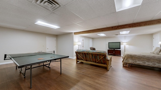 playroom with a drop ceiling and hardwood / wood-style floors