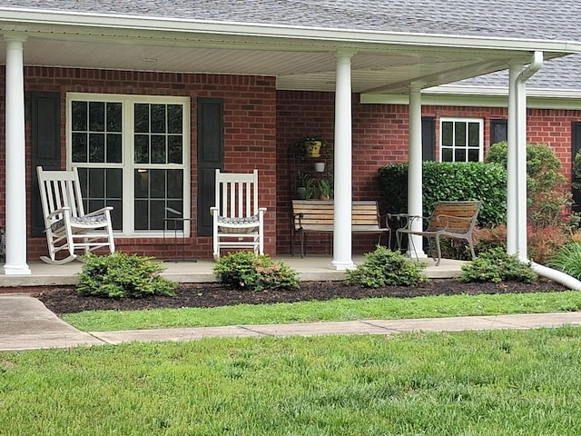 1253 White Rd, Bon Aqua, TN 37025 - doorway to property featuring a porch, roof with shingles, and brick siding
